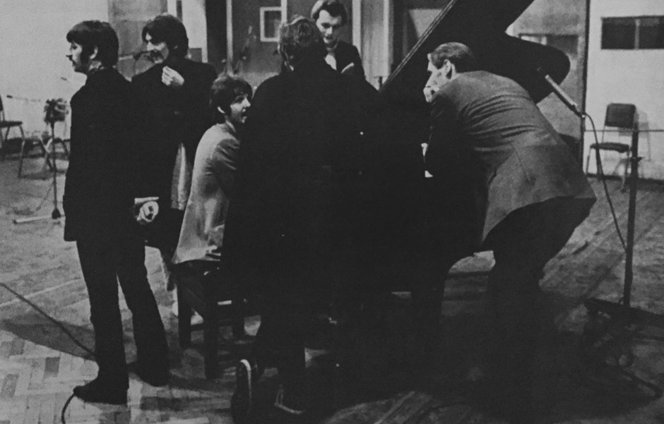 Watched by musical scholar George Martin (right), the new Beatles prepare to record. From left, Ringo Starr, George Harrison, Paul McCartney (seated) and John Lennon (back to camera) in London EMI Studios
